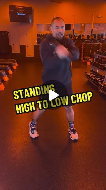 Dumbbell standing high to low chop